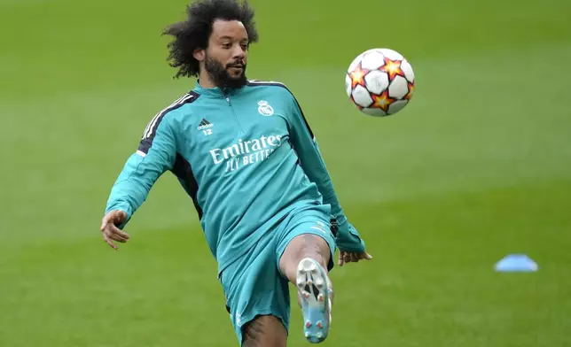 FILE - Real Madrid's Marcelo controls the ball during a training session ahead of Wednesday's Champions League first-leg quarterfinal soccer match between Chelsea and Real Madrid at Stamford Bridge stadium in London Tuesday, April 5, 2022. (AP Photo/Kirsty Wigglesworth, File)