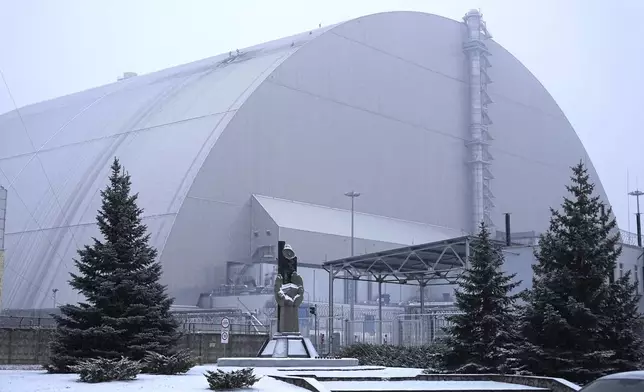 A view of the containment vessel that protects the remains of reactor number four at the former Chernobyl nuclear power plant and built to contain radiation, after a drone attack, Ukraine, Friday, Feb. 14, 2025. (AP Photo/Efrem Lukatsky)
