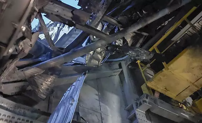 In this photo provided by the Ukrainian Emergency Service, damaged sarcophagus that covers the destroyed 4th reactor of Chernobyl nuclear power plant is seen from inside following a Russian drone attack in Chernobyl, Ukraine, Friday, Feb. 14, 2025. (Ukrainian Emergency Service via AP)