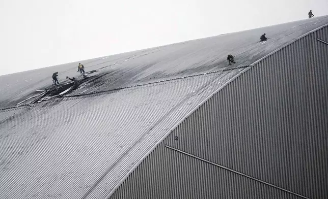 A view of the containment vessel that protects the remains of reactor number four at the former Chernobyl nuclear power plant and built to contain radiation, after a drone attack in Chernobyl, Ukraine, Friday, Feb. 14, 2025. (AP Photo/Efrem Lukatsky)