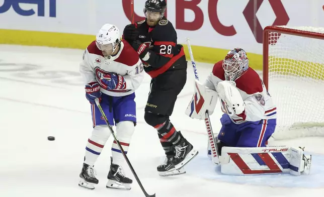 Montreal Canadiens' Alex Newhook (15) and Ottawa Senators' Claude Giroux (28) jostle in front of Montreal Canadiens' goaltender Sam Montembeault (35)during second period NHL hockey action in Ottawa on Saturday, Feb. 22, 2025. (Patrick Doyle/The Canadian Press via AP)