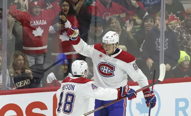 Montreal Canadiens' Patrik Laine (92) celebrates his goal with teammate Lane Hutson (48) during first period NHL hockey action against the Ottawa Senators in Ottawa on Saturday, Feb. 22, 2025. (Patrick Doyle/The Canadian Press via AP)
