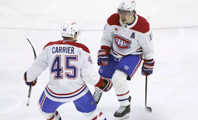 Montreal Canadiens' Brendan Gallagher (11) celebrates his goal with teammate Alexandre Carrier (45) during first period NHL hockey action against the Ottawa Senators in Ottawa on Saturday, Feb. 22, 2025. (Patrick Doyle/The Canadian Press via AP)