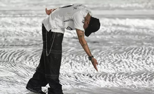 Brazilian soccer player Neymar greets fans during his presentation ceremony after signing a six-month contract with Santos FC at Vila Belmiro Stadium in Santos, Brazil, Friday, Jan. 31, 2025. (AP Photo/Andre Penner)