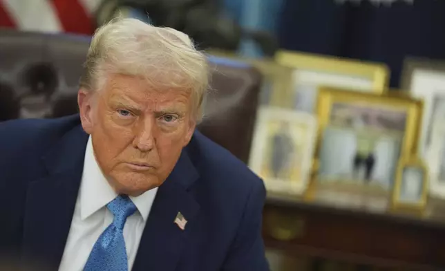 President Donald Trump speaks to reporters as he signs executive orders in the Oval Office of the White House, Friday, Jan. 31, 2025, in Washington. (AP Photo/Evan Vucci)