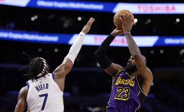 Los Angeles Lakers forward LeBron James shoots a jumper against Golden State Warriors guard Buddy Hield during the second half of an NBA basketball game Thursday, Feb. 6, 2025, in Los Angeles. (AP Photo/Kevork Djansezian)