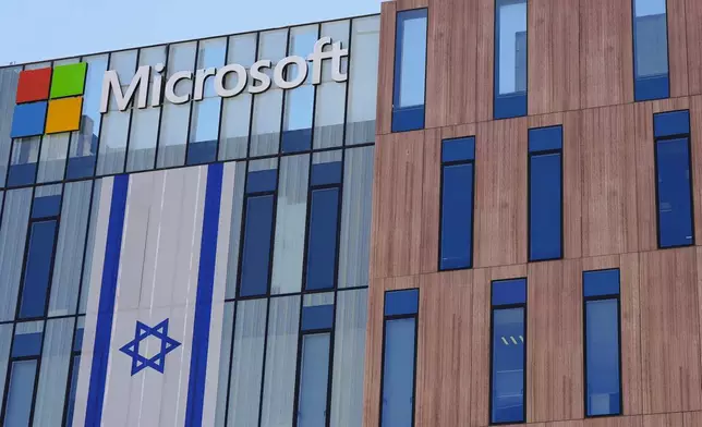 An Israeli flag is draped over the Microsoft offices in a building in the Gav Yam technology park in Beersheba, Israel, on Thursday, May 30, 2024. (AP Photo/Sam Mednick)
