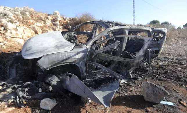 The remains of a Hyundai SUV are seen in the town of Ainata, a Lebanese border village with Israel in south Lebanon, Monday, Nov. 6, 2023, after Samira Ayoub, and her three granddaughters, Rimas, 14; Taline, 12, and Liane, 10, were killed in the car during an Israeli airstrike the previous evening. (AP Photo/Mohammed Zaatari)
