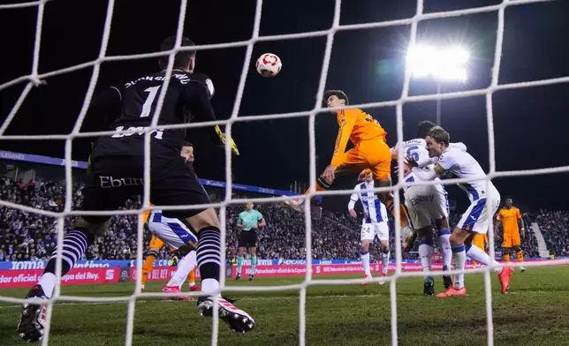 Real Madrid's Gonzalo Garcia, center, heads the ball to score his side's third goal past Leganes' goalkeeper Juan Soriano, left, during a Spanish Copa del Rey, or King's Cup, quarter-final soccer match between CD Leganes and Real Madrid at Butarque stadium, in Leganes, outside Madrid, Wednesday, Feb. 5, 2025. (AP Photo/Manu Fernandez)