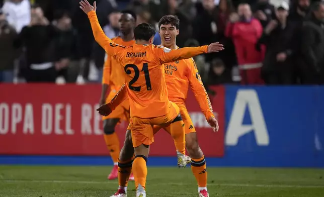 Real Madrid's Gonzalo Garcia, right, celebrates with teammate Brahim Diaz after scoring their side's third goal during a Spanish Copa del Rey, or King's Cup, quarter-final soccer match between CD Leganes and Real Madrid at Butarque stadium, in Leganes, outside Madrid, Wednesday, Feb. 5, 2025. (AP Photo/Manu Fernandez)