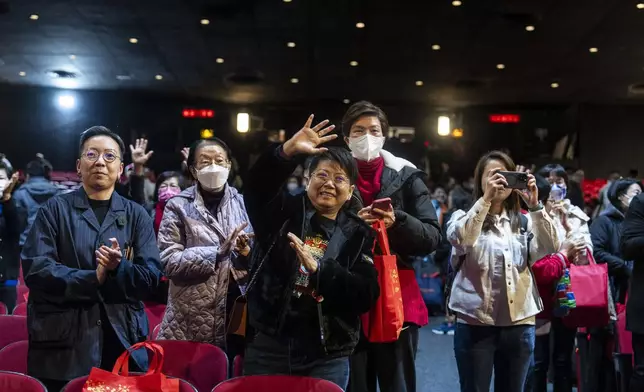 Members of the audience applaud after watching the Cantonese opera “Trump on Show” at the Sunbeam Theatre in Hong Kong, Monday, Feb. 3, 2025. (AP Photo/Chan Long Hei)
