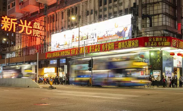 People queue outside the Sunbeam Theatre that is currently playing the Cantonese opera production “Trump on Show” in Hong Kong, Monday, Feb. 3, 2025. (AP Photo/Chan Long Hei)