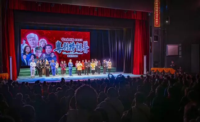 Opera playwright Li Kui-Ming and other actors stand on stage at the end of a performance of the Cantonese opera “Trump on Show” at the Sunbeam Theatre in Hong Kong, Monday, Feb. 3, 2025. (AP Photo/Chan Long Hei)