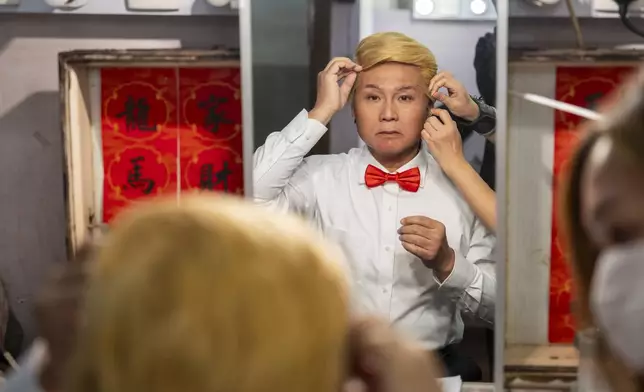 Cantonese opera actor Lung Koon-tin portraying U.S. President Donald Trump prepares for the “Trump on Show” production at the Sunbeam Theatre in Hong Kong, Monday, Feb. 3, 2025. (AP Photo/Chan Long Hei)