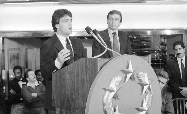 FILE - Doug Flutie, the New Jersey Generals newly-signed quarterback, talks to reporters during a news conference in New York, Feb. 6, 1985, after he was signed by the team's owner, Donald Trump, right, for four years at approximately $7 million. (AP Photo/Marty Lederhandler, File)