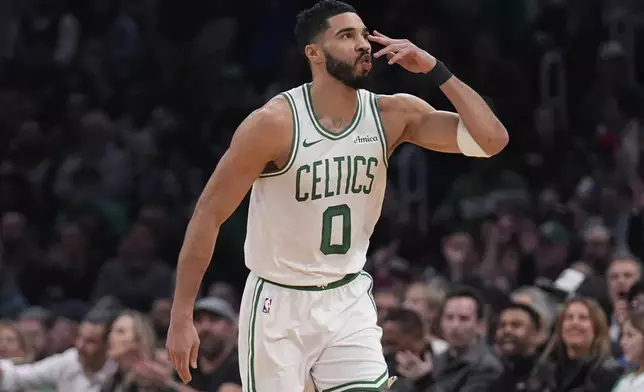 Boston Celtics forward Jayson Tatum blows a kiss after hitting a 3-pointer against the San Antonio Spurs during the first half of an NBA basketball game, Wednesday, Feb. 12, 2025, in Boston. (AP Photo/Charles Krupa)
