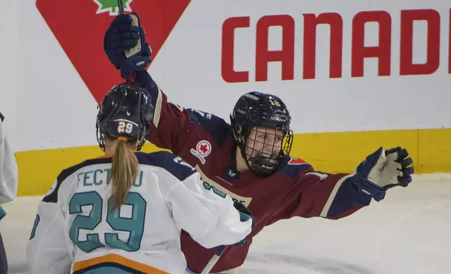 Montreal Victoire's Jennifer Gardiner (12) celebrates scoring agians thte New York Sirens during the first period of a PWHL hockey game in Laval, Quebec, Saturday, Feb. 15, 2025. (Peter McCabe/The Canadian Press via AP)