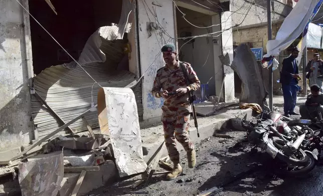 A security official checks the site of a bomb blast in Quetta, Pakistan, Friday, Feb. 28, 2025. (AP Photo/Arshad Butt)