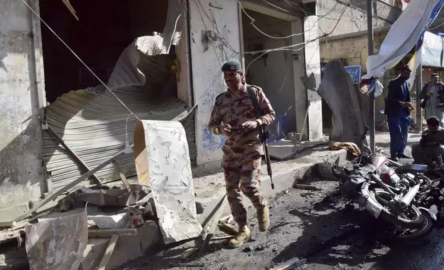 Security official checks at the site of a bomb blast in Quetta, Pakistan, Friday, Feb. 28, 2025. (AP Photo/Arshad Butt)