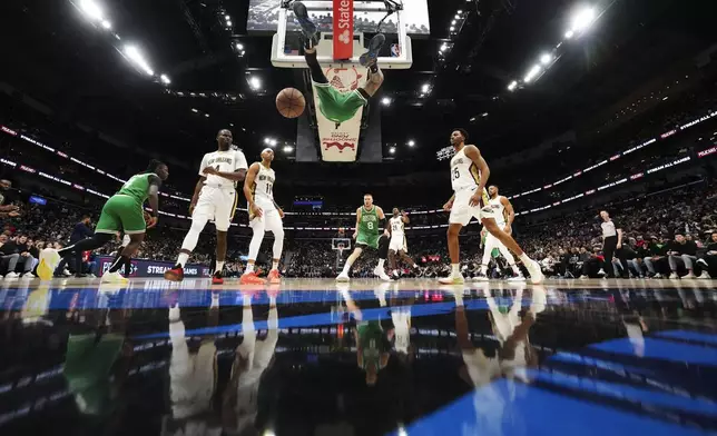 Boston Celtics forward Jayson Tatum slam dunks in the second half of an NBA basketball game against the New Orleans Pelicans in New Orleans, Friday, Jan. 31, 2025. (AP Photo/Gerald Herbert)
