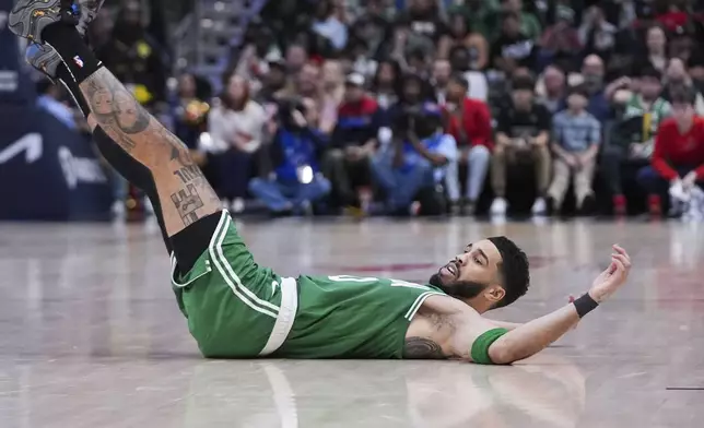 Boston Celtics forward Jayson Tatum falls to the court after being fouled in the second half of an NBA basketball game against the New Orleans Pelicans in New Orleans, Friday, Jan. 31, 2025. (AP Photo/Gerald Herbert)