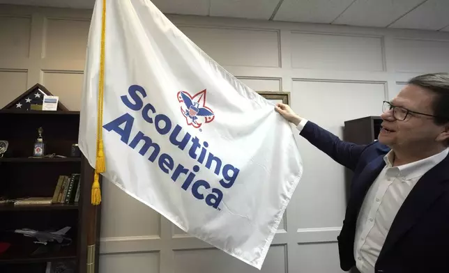 Michael Ramsey displays the Scouting America flag at the organization's headquarters in Irving, Texas, Wednesday, Feb. 5, 2025. (AP Photo/LM Otero)
