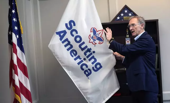 Roger Krone, chief executive officer of Scouting America, describes the design of the organization's flag in Irving, Texas, Wednesday, Feb. 5, 2025. (AP Photo/LM Otero)