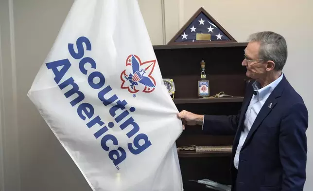 Roger Krone, chief executive officer of Scouting America, describes the design of the organization's flag in Irving, Texas, Wednesday, Feb. 5, 2025. (AP Photo/LM Otero)