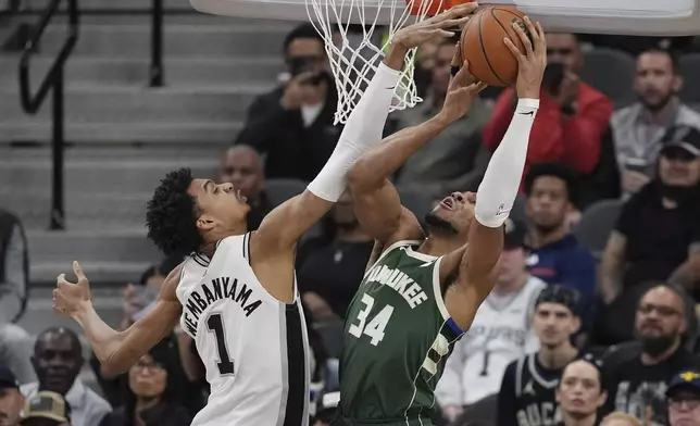 Milwaukee Bucks forward Giannis Antetokounmpo (34) is blocked by San Antonio Spurs center Victor Wembanyama (1) during the first half of an NBA basketball game in San Antonio, Friday, Jan. 31, 2025. (AP Photo/Eric Gay)