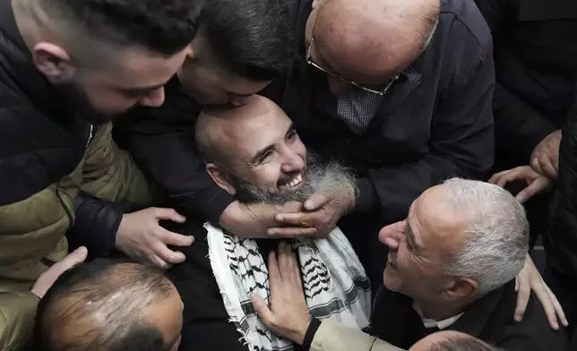 Palestinian prisoner Waddeh Bazrah, 43, is greeted after being released from Israeli prison following a ceasefire agreement between Israel and Hamas, in the West Bank city of Ramallah, Saturday, Feb. 15, 2025. (AP Photo/Mahmoud Illean)