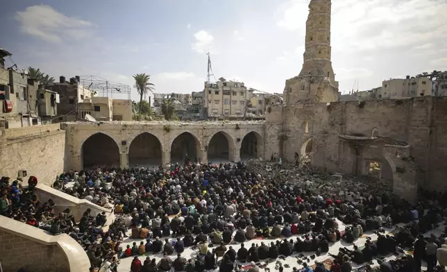 Palestinians gather to attend Friday prayers at the Great Omari Mosque, which was damaged during the Israeli military's air and ground operation in Gaza City, Friday, Feb. 14, 2025. (AP Photo/Jehad Alshrafi)