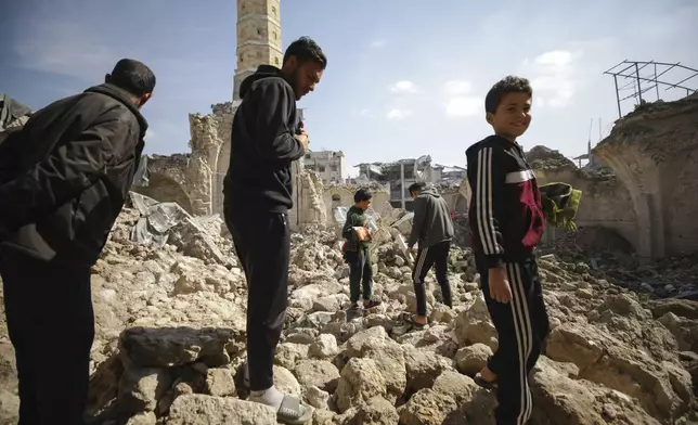 Palestinians gather to attend the Friday prayers at the Great Omari Mosque, which was damaged during the Israeli military's air and ground operation in Gaza City, Friday, Feb. 14, 2025. (AP Photo/Jehad Alshrafi)