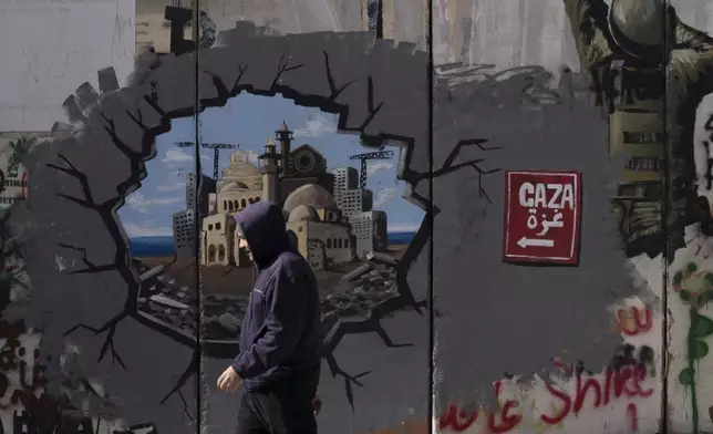 Graffiti on Israel's separation barrier depicts the Gaza Strip, in the West Bank city of Bethlehem, Friday, Feb. 14, 2025. (AP Photo/Maya Alleruzzo)