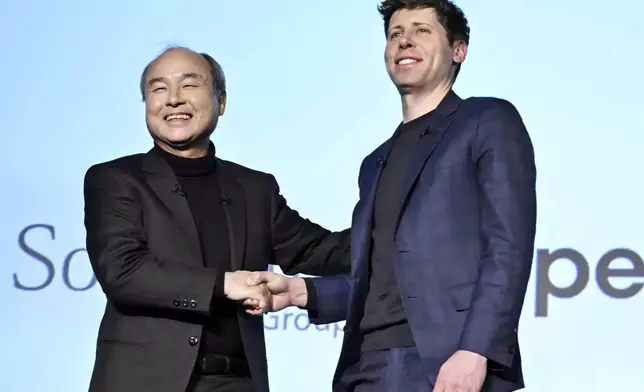 SoftBank Chief Masayoshi Son, left, and OpenAI Chief Sam Altman shake hands during an event in Tokyo, in Tokyo, Monday, Feb. 3, 2025. (Kyodo News via AP)