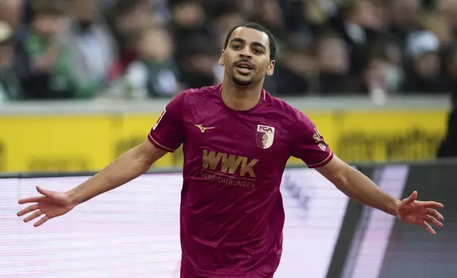 Augsburg's Alexis Claude-Maurice celebrates after scoring during the German Bundesliga soccer match between Borussia Moenchengladbach and FC Augsburg in Moenchengladbach, Germany, Saturday, Feb. 22, 2025. (Marius Becker/dpa via AP)