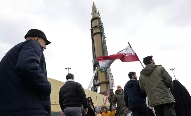 Iranian demonstrators march next to a domestically-built missile during a rally commemorating anniversary of 1979 Islamic Revolution that toppled the late pro-U.S. Shah Mohammad Reza Pahlavi and brought Islamic clerics to power, in Tehran, Iran, Monday, Feb. 10, 2025. (AP Photo/Vahid Salemi)