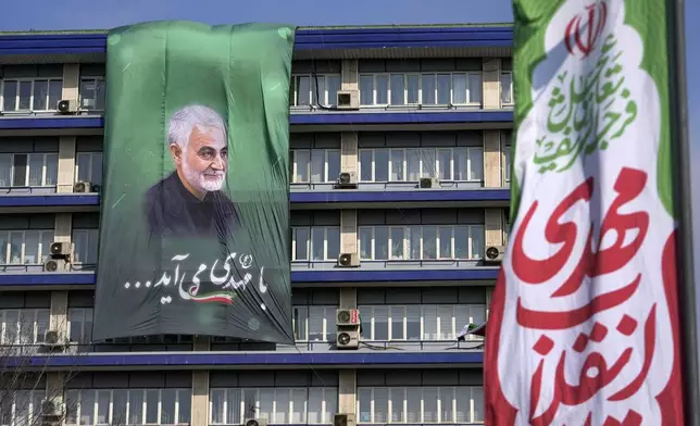 A portrait of the late Iranian Revolutionary Guard Gen. Qassem Soleimani, who was killed in a U.S. drone attack in 2020, hangs on a government building during a rally commemorating anniversary of 1979 Islamic Revolution that toppled the late pro-U.S. Shah Mohammad Reza Pahlavi and brought Islamic clerics to power, in Tehran, Iran, Monday, Feb. 10, 2025. (AP Photo/Vahid Salemi)