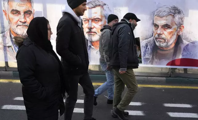 People march in front of portraits of the late Hamas leaders Yahya Sinwar, right, Ismail Haniyeh, center, who were killed by Israel and the late Iran's Revolutionary Guard Gen. Qassem Soleimani, who was killed in a U.S. drone attack in 2020, in a rally commemorating the anniversary of Iran's 1979 Islamic Revolution, in Tehran, Iran, Monday, Feb. 10, 2025. (AP Photo/Vahid Salemi)