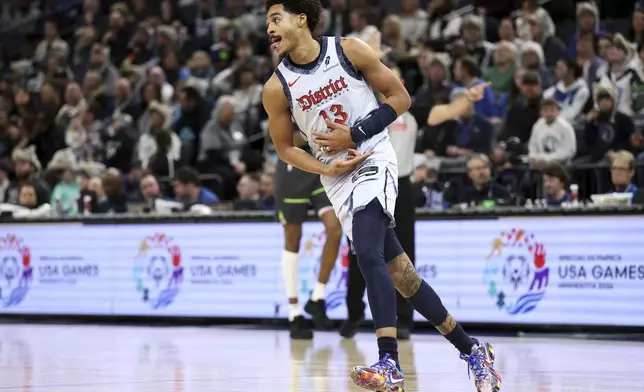 Washington Wizards guard Jordan Poole (13) celebrates his three-point basket against the Minnesota Timberwolves during the first half of an NBA basketball game Saturday, Feb. 1, 2025, in Minneapolis. (AP Photo/Matt Krohn)