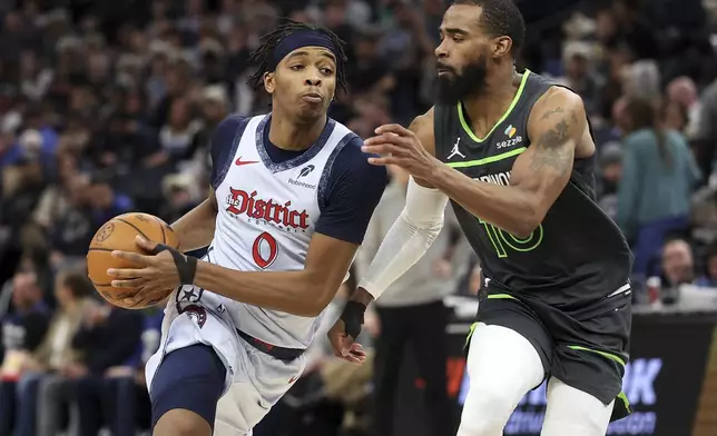 Washington Wizards guard Bilal Coulibaly, left, work around Minnesota Timberwolves guard Mike Conley during the second half of an NBA basketball game Saturday, Feb. 1, 2025, in Minneapolis. (AP Photo/Matt Krohn)