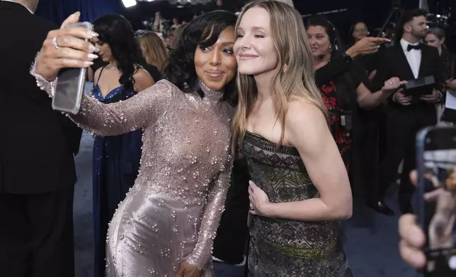 Kerry Washington, left, and Kristen Bell take a selfie photograph at the 31st annual Screen Actors Guild Awards on Sunday, Feb. 23, 2025, at the Shrine Auditorium in Los Angeles. (AP Photo/Chris Pizzello)