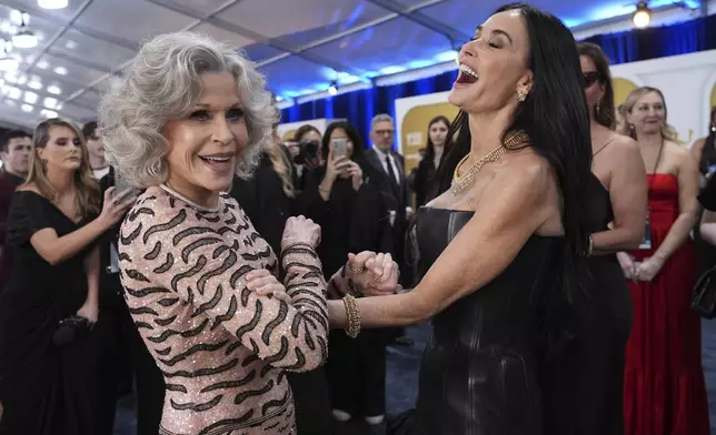 Jane Fonda, left, and Demi Moore arrive at the 31st annual Screen Actors Guild Awards on Sunday, Feb. 23, 2025, at the Shrine Auditorium in Los Angeles. (AP Photo/Chris Pizzello)