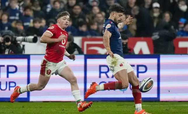 France's Romain Ntamack kicks cross field during the Six Nations rugby union match between France and Wales at the Stade de France in Saint-Denis, outside Paris, Friday, Jan. 31, 2025. (AP Photo/Michel Euler)