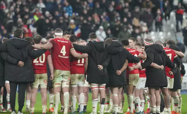 Wales players gather in a huddle after losing the Six Nations rugby union match between France and Wales at the Stade de France in Saint-Denis, outside Paris, Friday, Jan. 31, 2025. (AP Photo/Michel Euler)