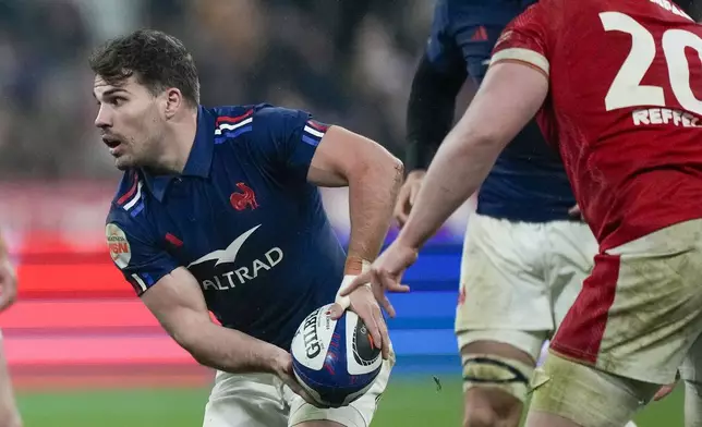 France's Antoine Dupont passes the ball during the Six Nations rugby union match between France and Wales at the Stade de France in Saint-Denis, outside Paris, Friday, Jan. 31, 2025. (AP Photo/Michel Euler)