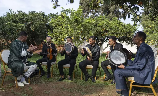 A music band prepares for a traditional performance known as Aita, in Sidi Yahya Zaer, south of the capital Rabat, Morocco, Monday, Jan. 27, 2025. (AP Photo/Mosa'ab Elshamy)