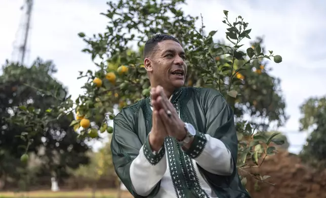 Rachid Kadari claps as he prepares for a traditional performance known as Aita, in Sidi Yahya Zaer, south of the capital Rabat, Morocco, Monday, Jan. 27, 2025. (AP Photo/Mosa'ab Elshamy)