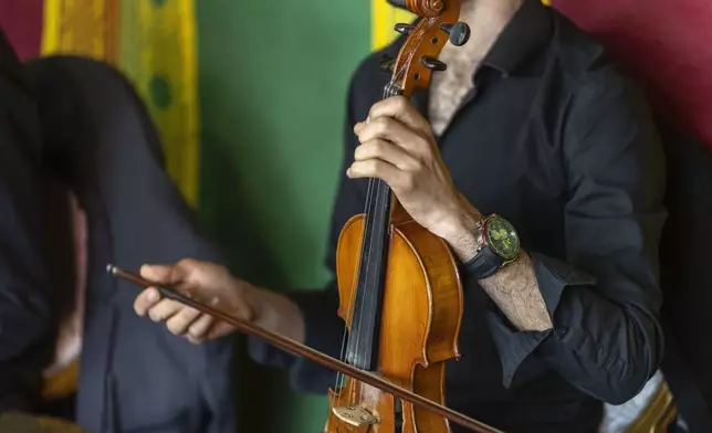 A violinist plays during a traditional performance known as Aita, in Sidi Yahya Zaer, south of the capital Rabat, Morocco, Monday, Jan. 27, 2025. (AP Photo/Mosa'ab Elshamy)