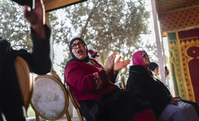 Women cheer along during a traditional performance known as Aita, in Sidi Yahya Zaer, south of the capital Rabat, Morocco, Monday, Jan. 27, 2025. (AP Photo/Mosa'ab Elshamy)