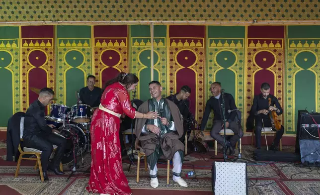 Cheikha folk singer Mbarka "Thouria" Moullablad talks to her band during a traditional performance known as Aita, in Sidi Yahya Zaer, south of the capital Rabat, Morocco, Monday, Jan. 27, 2025. (AP Photo/Mosa'ab Elshamy)